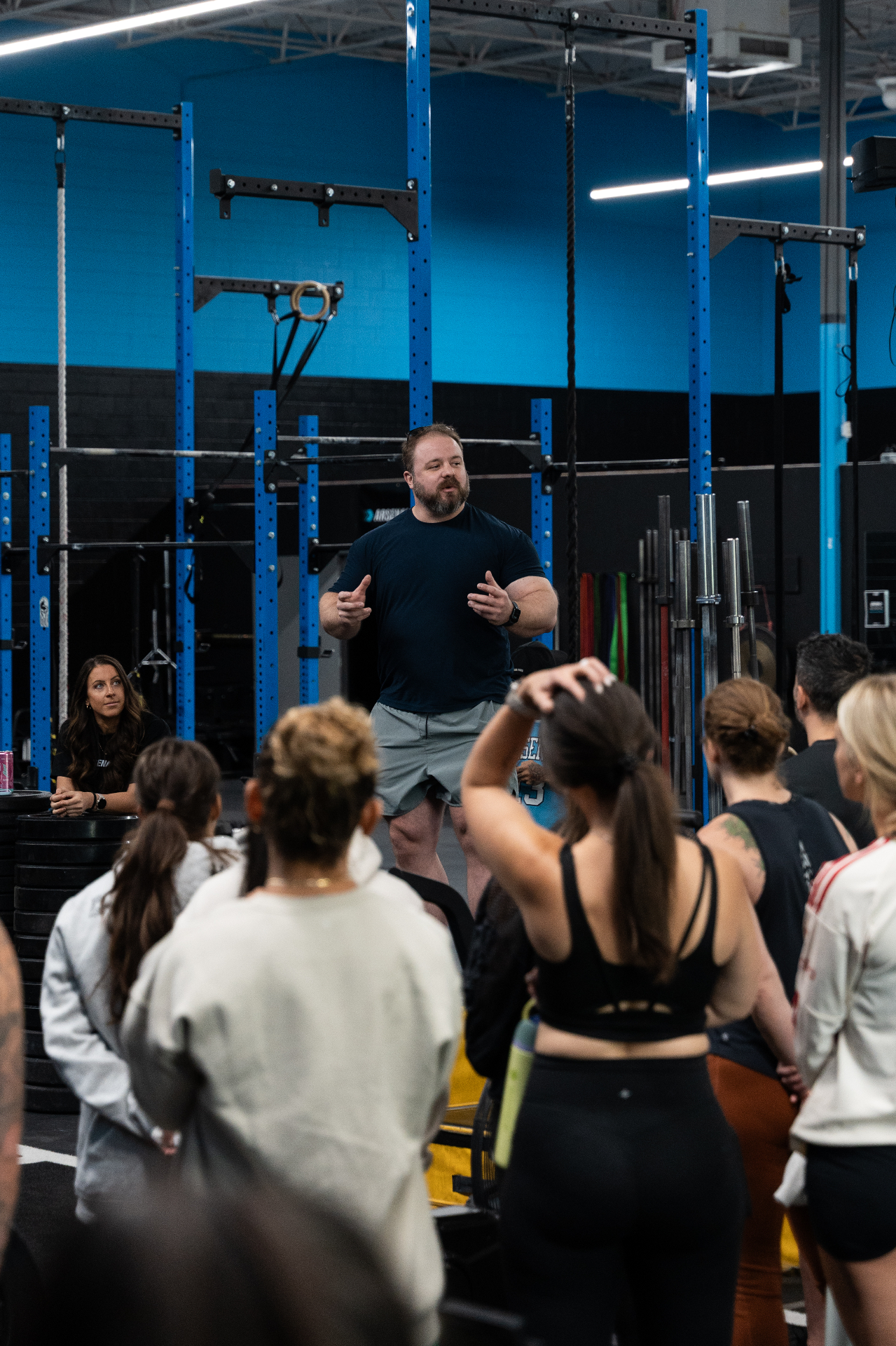 Chad Adams coaching a group of athletes in the gym